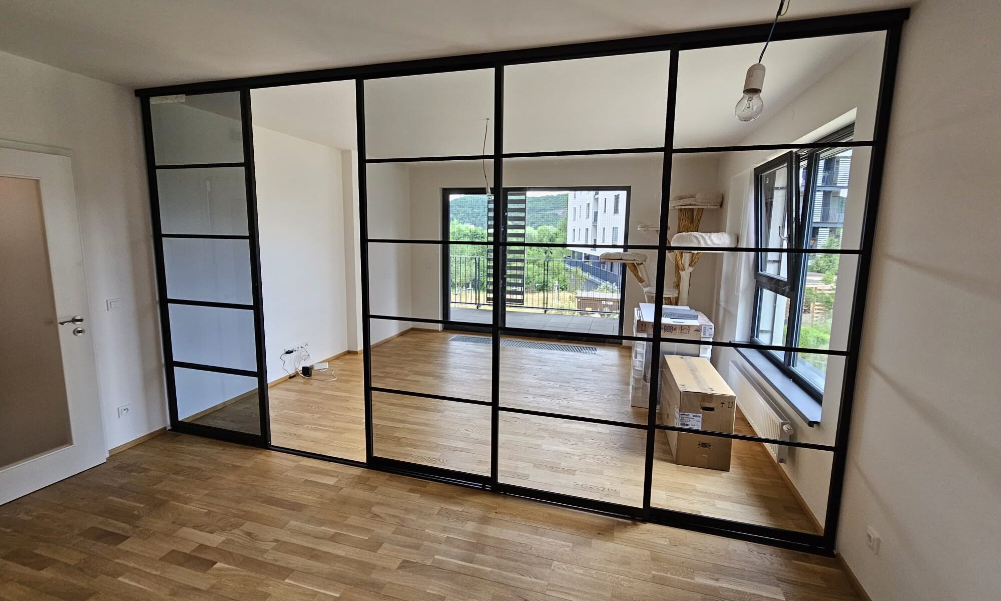 posuvná dělící příčka od Mline - černý hliník, kalené sklo, planibel šedý